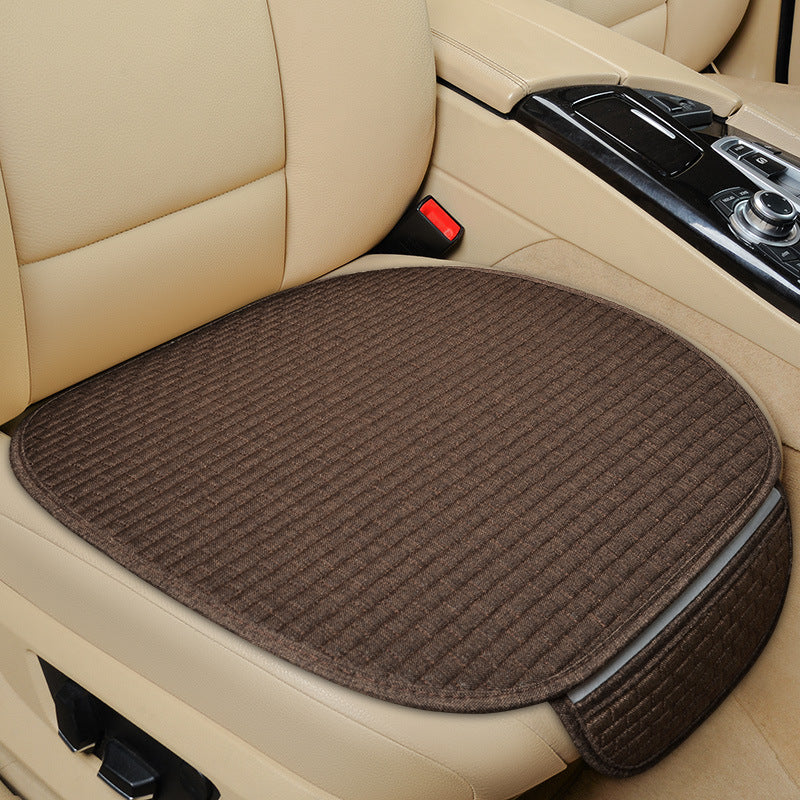 Brown car seat cushion on a beige car seat