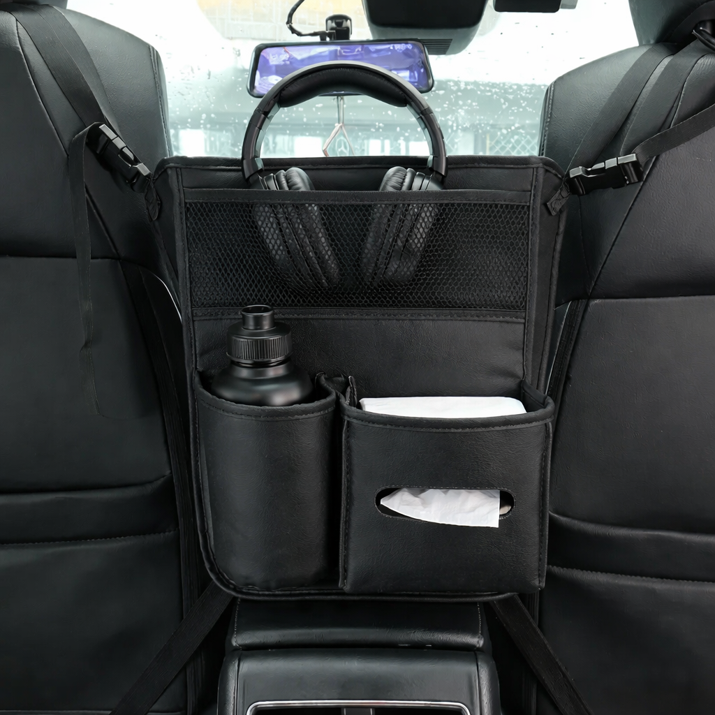 Car organizer with pockets holding a bottle, tissues, and headphones in a vehicle's back seat.