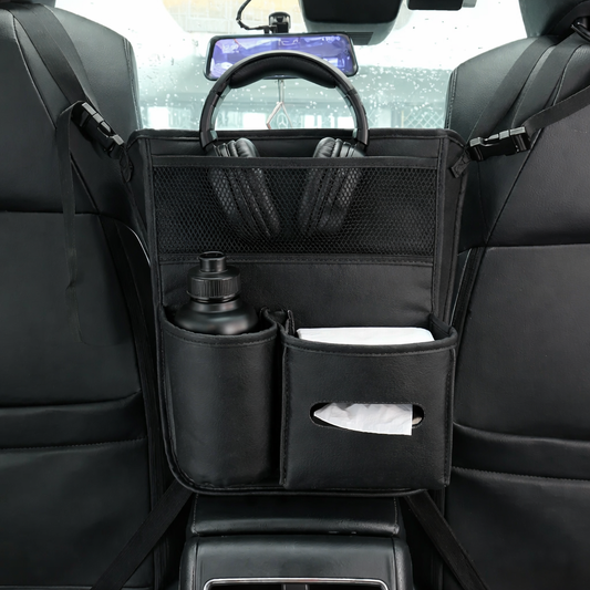 Car organizer with pockets holding a bottle, tissues, and headphones in a vehicle's back seat.