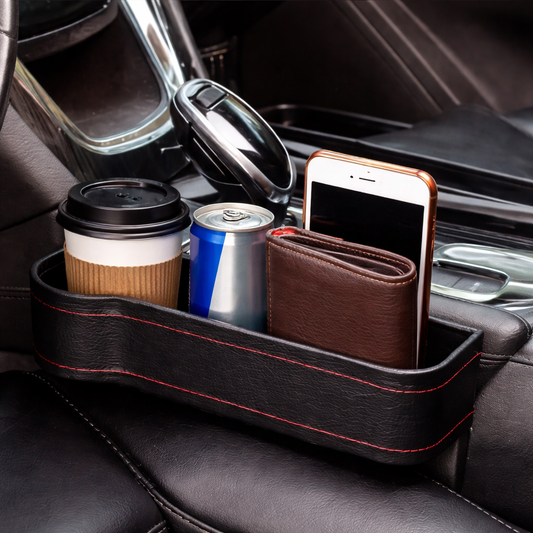 Car cup holder organizer with coffee, can, and phone inside a car.